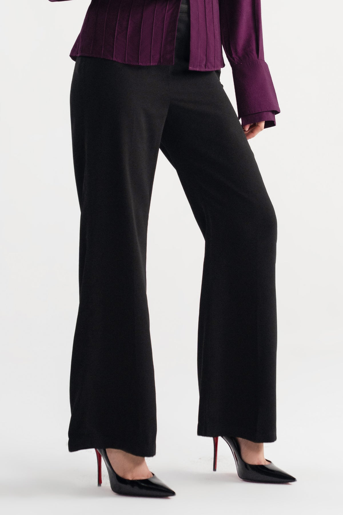 Black high waisted clean wide leg tailored, worn by a model, by SOLA Pakistan.
