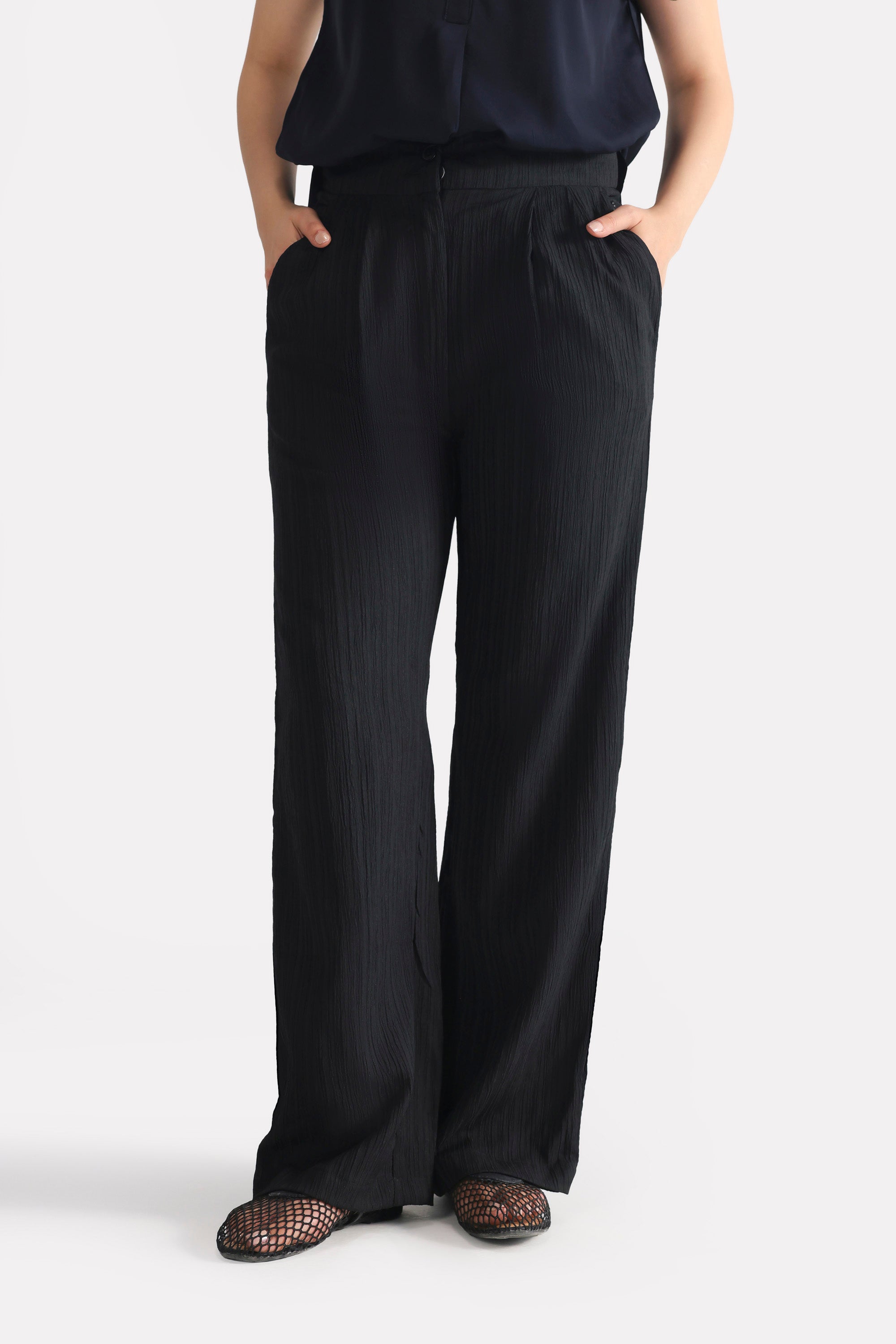 Black retro wide-leg trouser shown in a styled fit, by SOLA Pakistan.