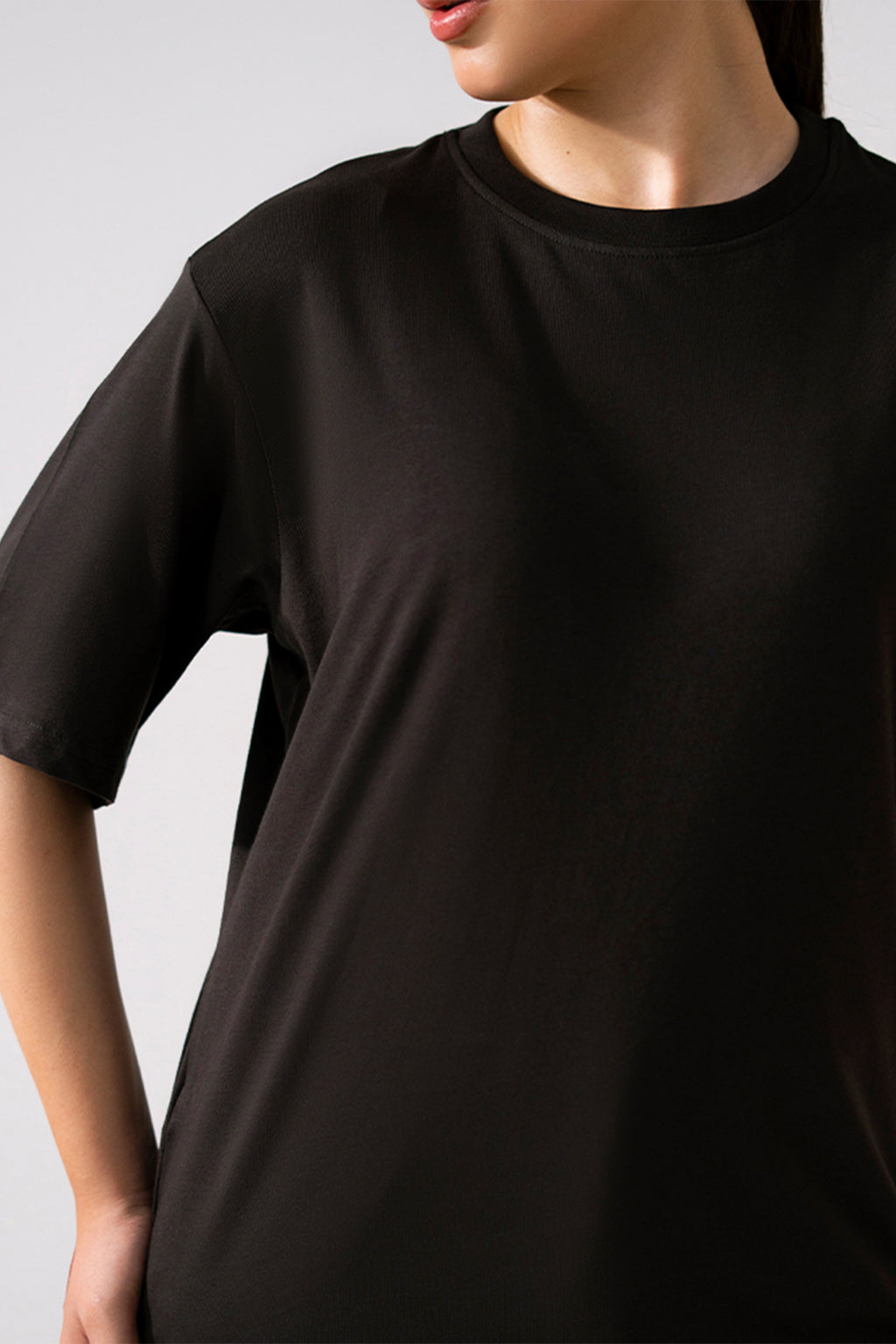 Close-up detail on the black round neck t-shirt, by SOLA Pakistan.