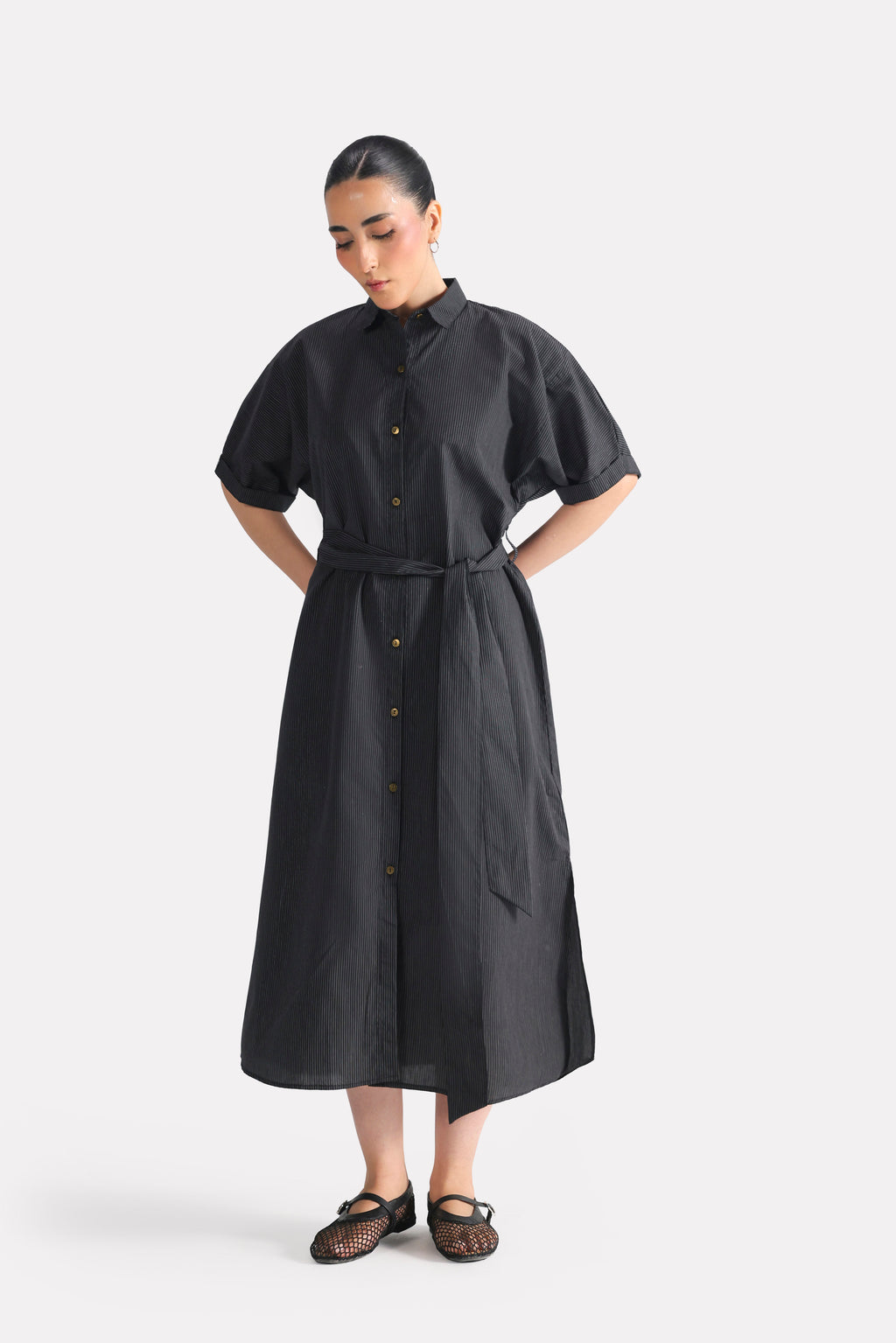 Flat lay of the black & white stripe striped cotton belted dress, by SOLA Pakistan.
