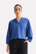 Blue (french blue) balloon sleeve relaxed top in cotton-linen blend, worn by a model, by SOLA Pakistan.