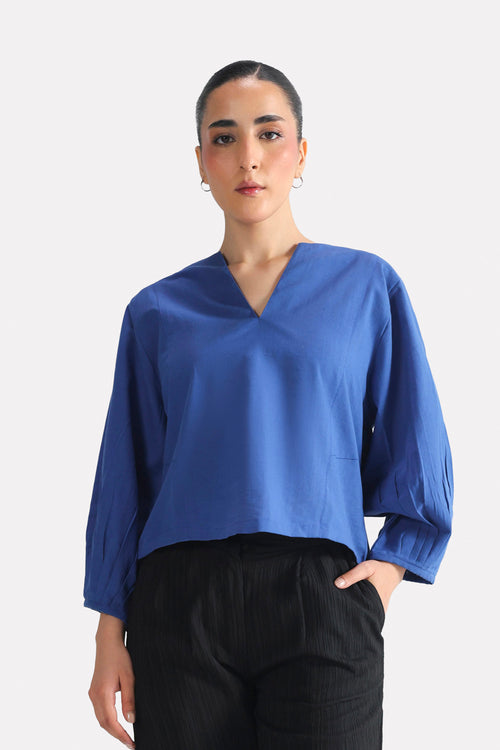 Blue (french blue) balloon sleeve relaxed top in cotton-linen blend, worn by a model, by SOLA Pakistan.