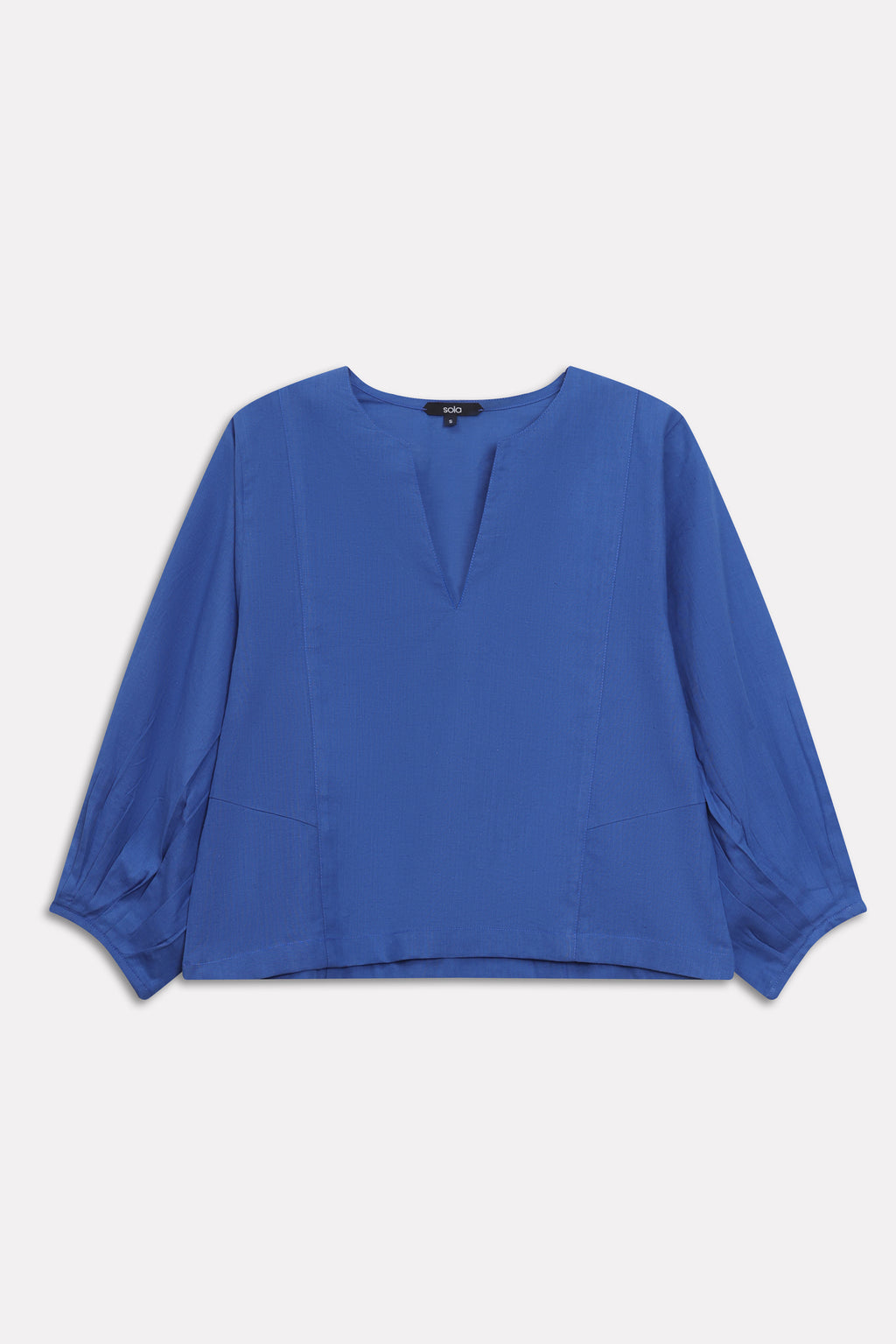 Blue (french blue) balloon sleeve relaxed top shown in a styled fit, by SOLA Pakistan.