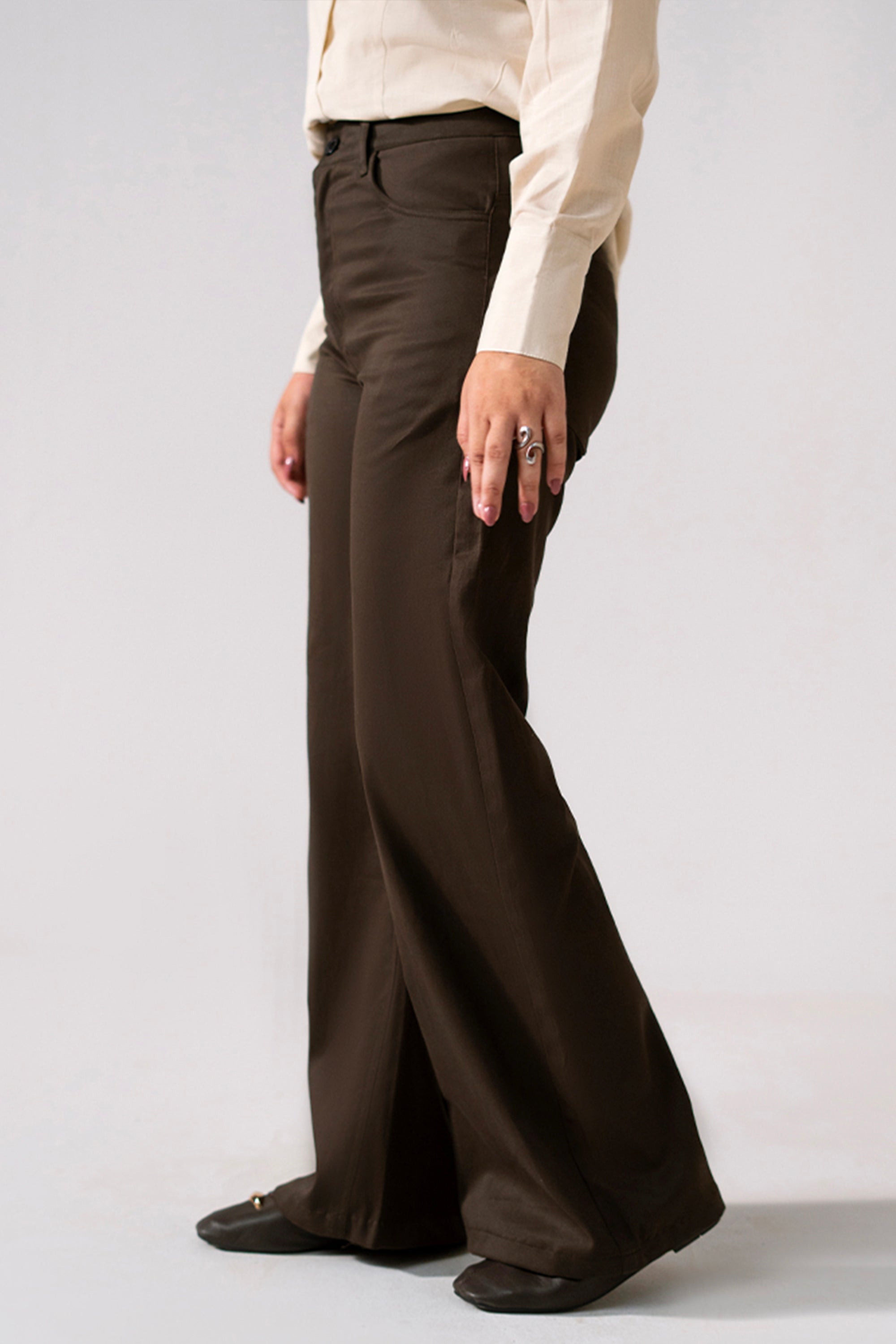 Close-up detail on the brown (turkish coffee) flared pant, by SOLA Pakistan.