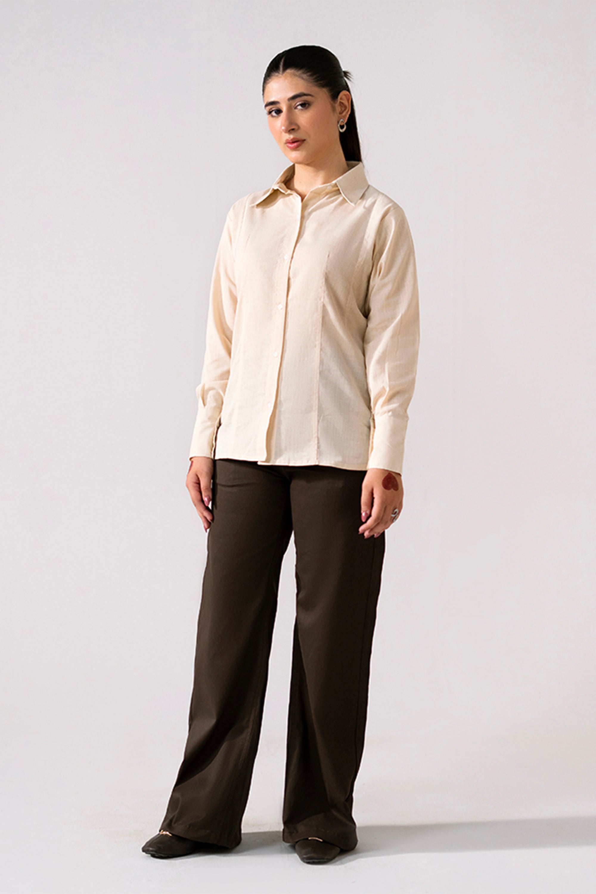 Brown (turkish coffee) flared pant in cotton, worn by a model, by SOLA Pakistan.