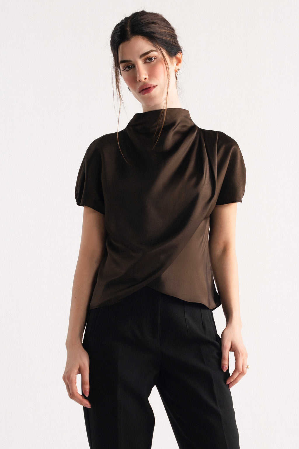 Close-up detail on the chocolate brown drapped high neck asymmetrical, by SOLA Pakistan.