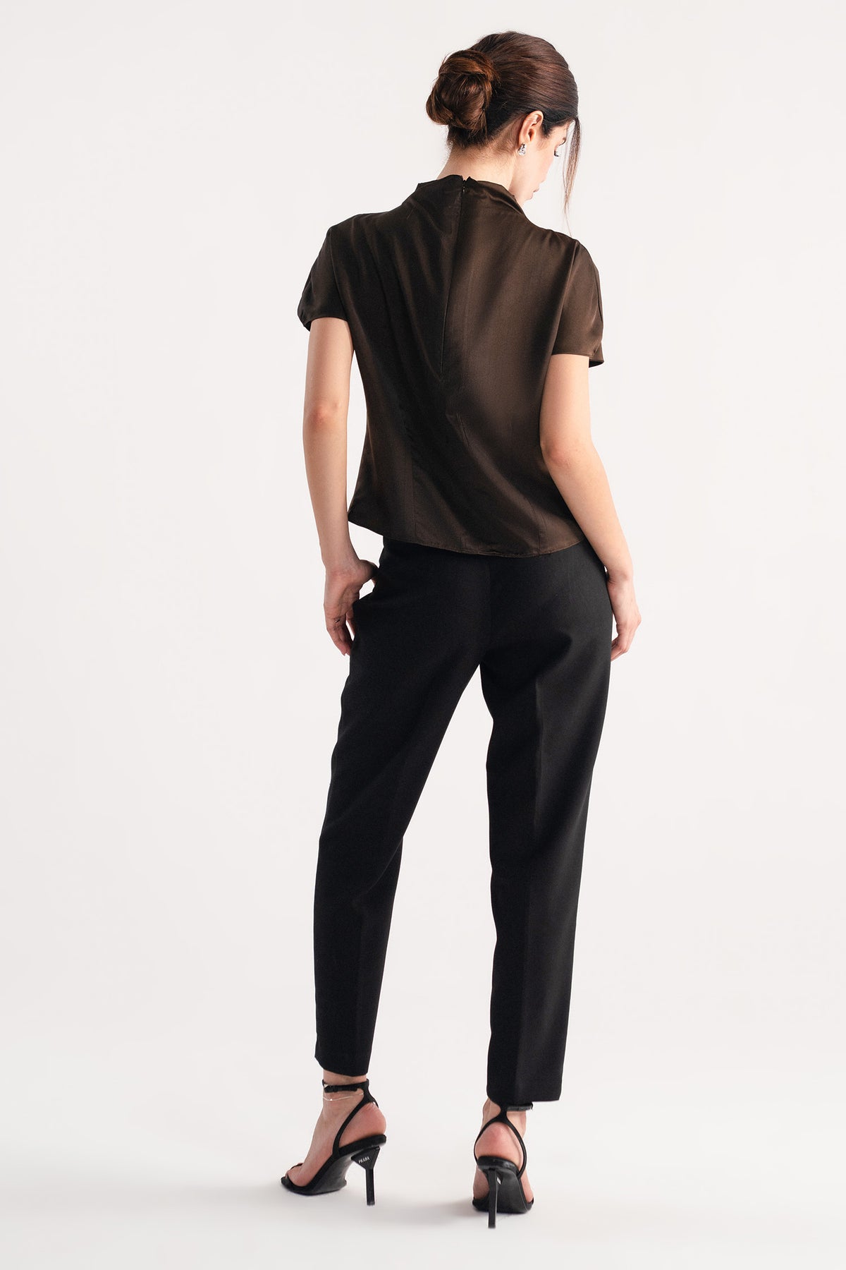 Flat lay of the chocolate brown drapped high neck asymmetrical, by SOLA Pakistan.