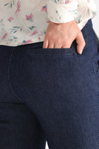 Close-up detail on the dark blue bootcut denim jean, by SOLA Pakistan.