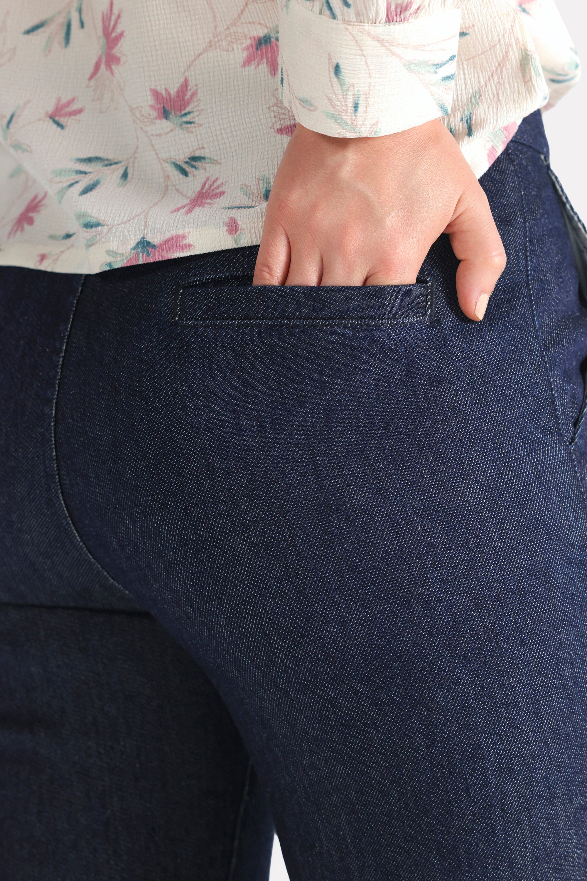 Close-up detail on the dark blue bootcut denim jean, by SOLA Pakistan.