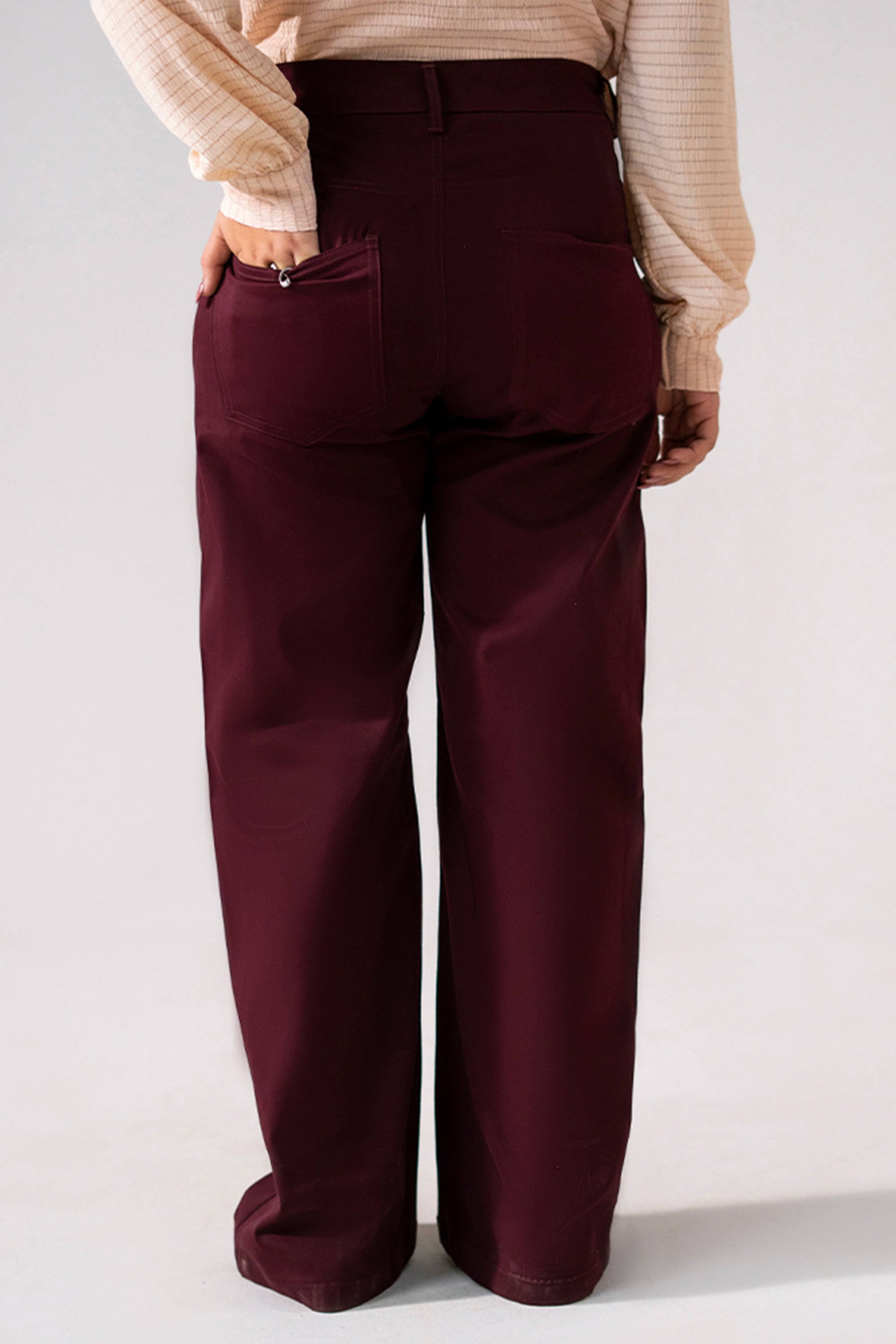 Close-up detail on the dark purple (plum) flared pant, by SOLA Pakistan.