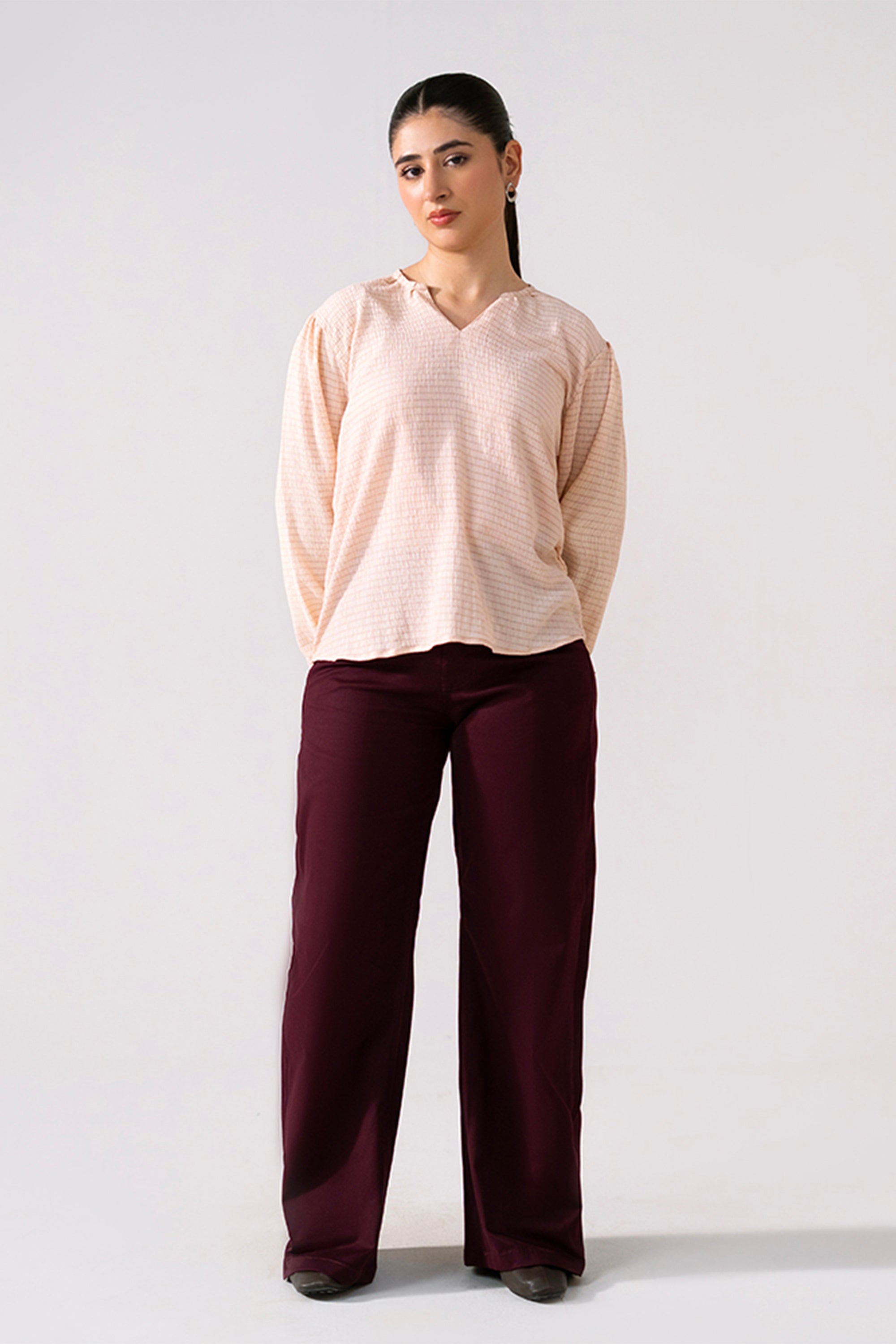 Dark purple (plum) flared pant in cotton, worn by a model, by SOLA Pakistan.
