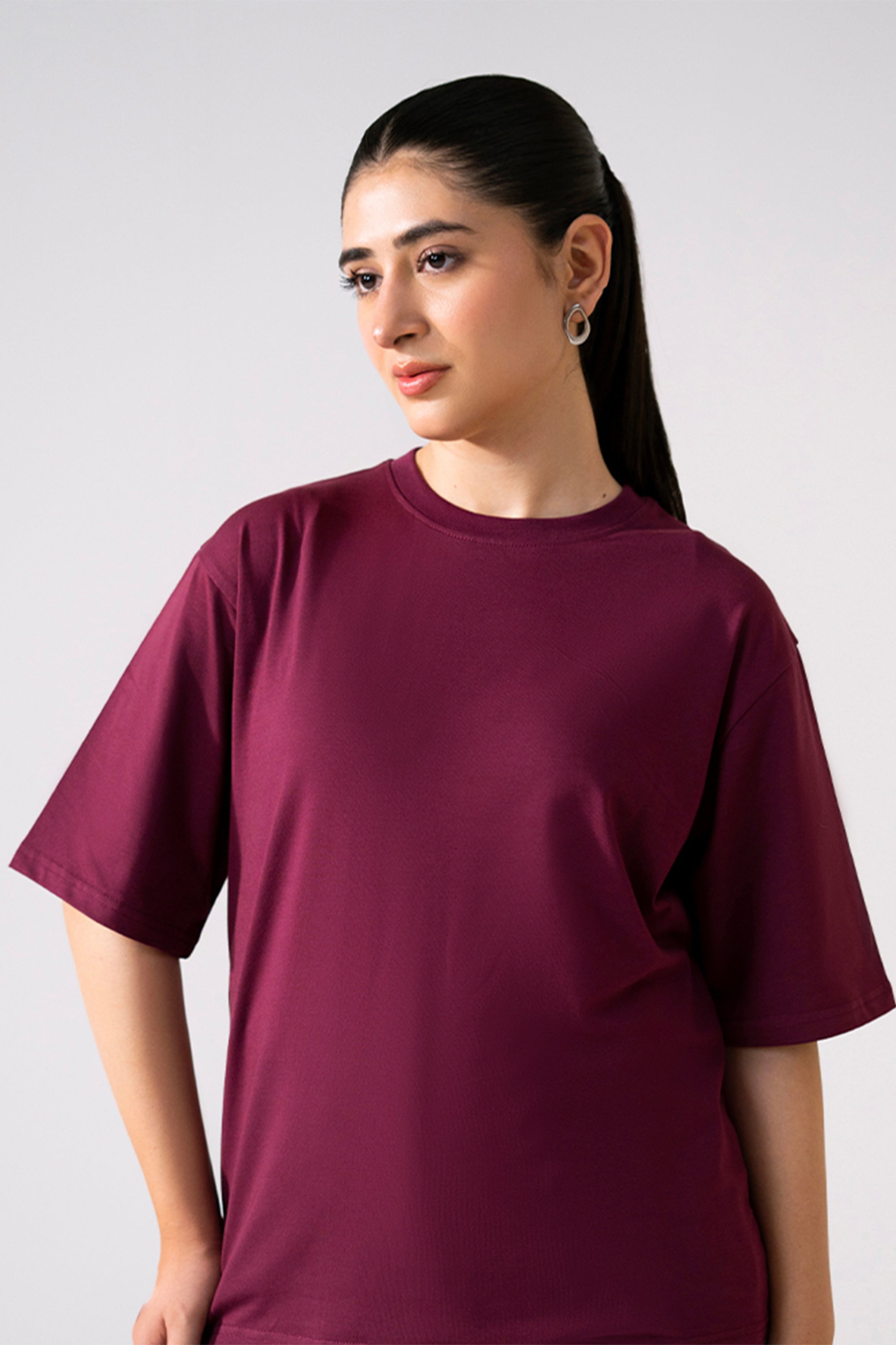 Close-up detail on the dark red (burgundy) round neck t-shirt, by SOLA Pakistan.