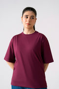Dark red (burgundy) round neck t-shirt in cotton, worn by a model, by SOLA Pakistan.