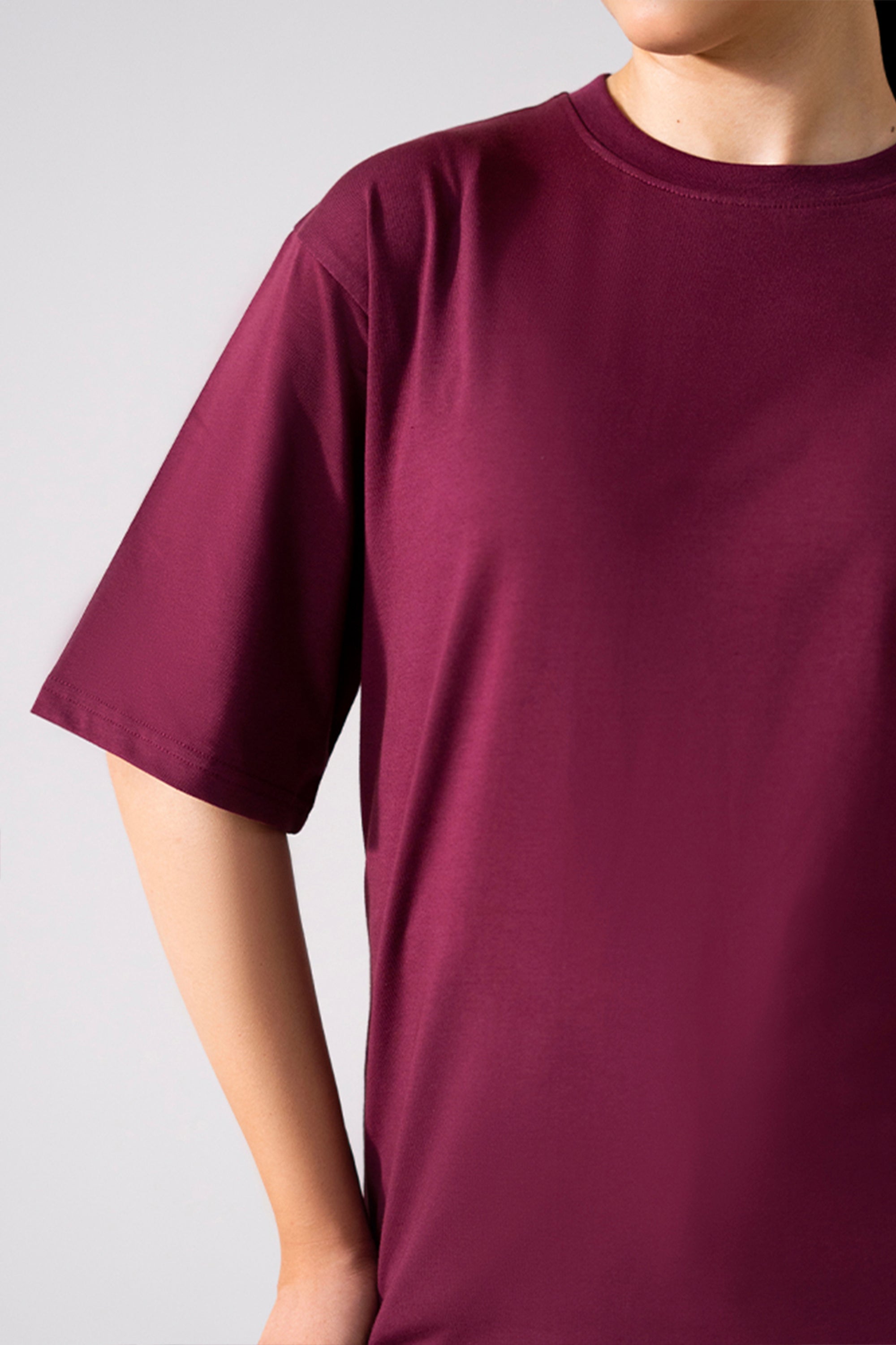 Dark red (burgundy) round neck t-shirt shown in a styled fit, by SOLA Pakistan.