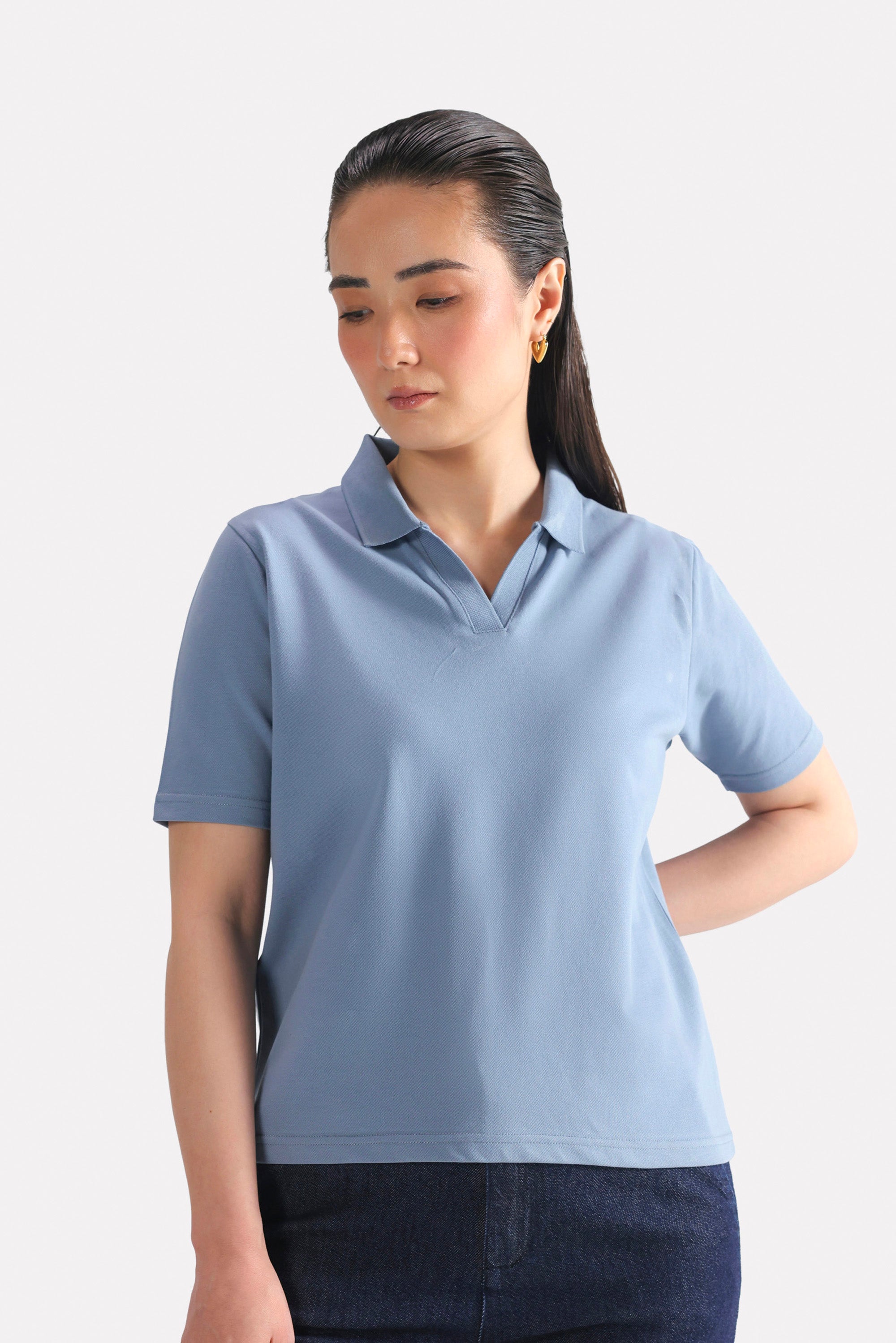 Faded blue (faded denim) jhonny collar polo t-shirt in cotton, worn by a model, by SOLA Pakistan.