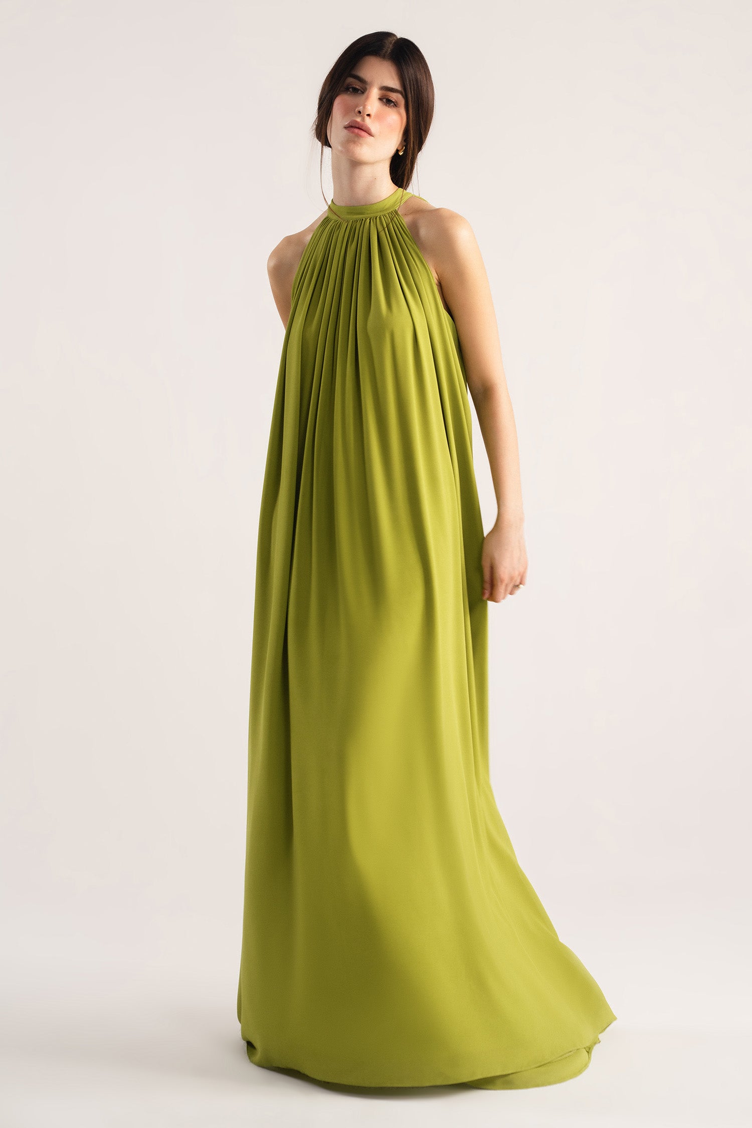 Green hatter neck a-line maxi dress, worn by a model, by SOLA Pakistan.