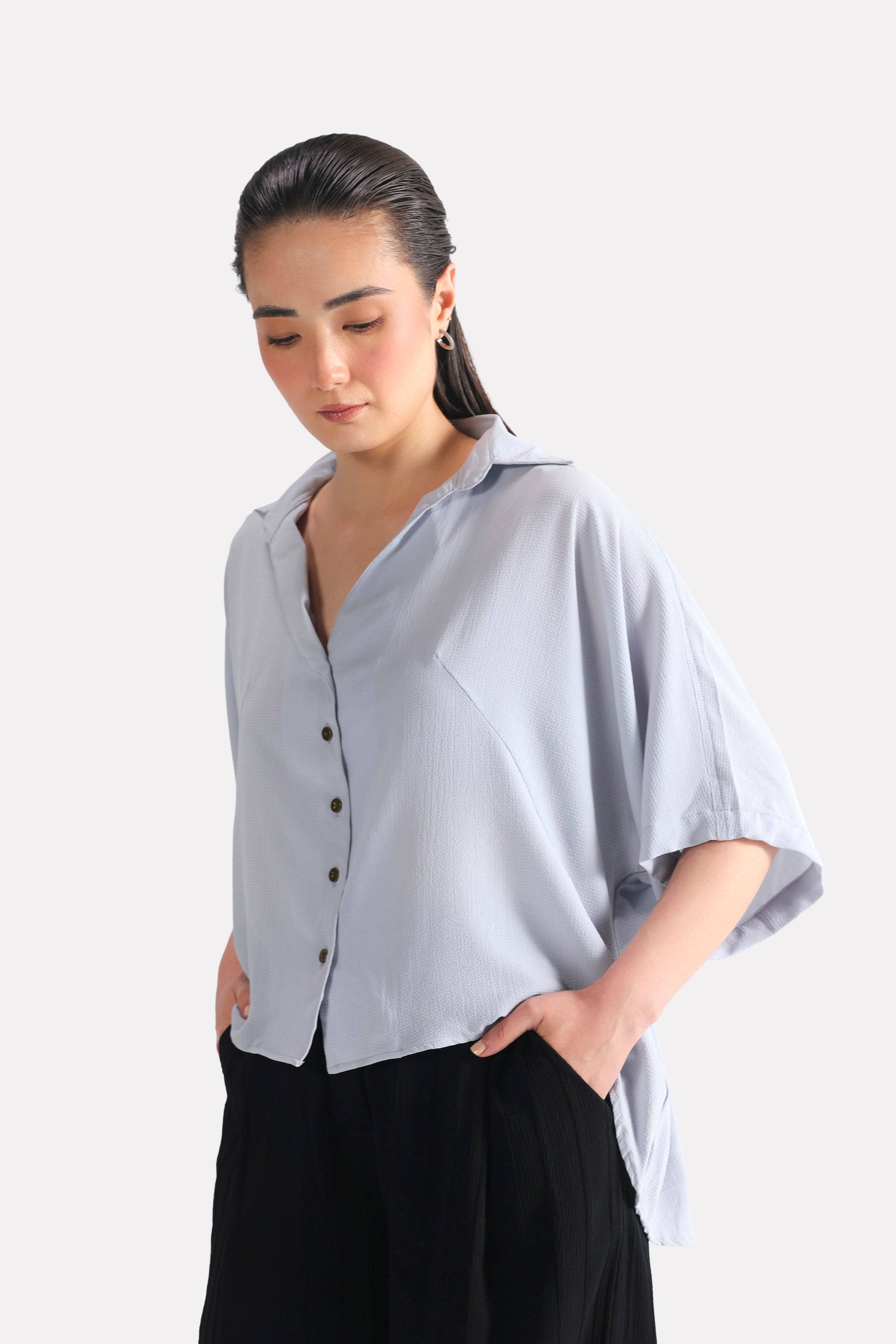 Grey bubble hem oversized top in viscose-cotton blend, worn by a model, by SOLA Pakistan.
