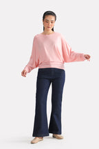 Close-up detail on the light pink fluid sleeve t-shirt, by SOLA Pakistan.