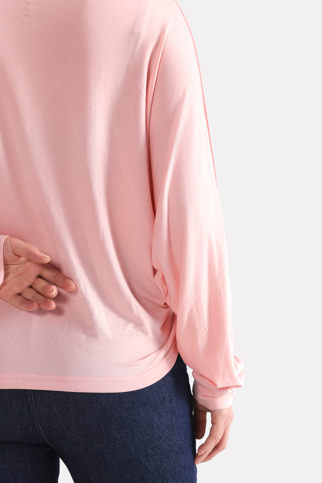 Flat lay of the light pink fluid sleeve t-shirt, by SOLA Pakistan.