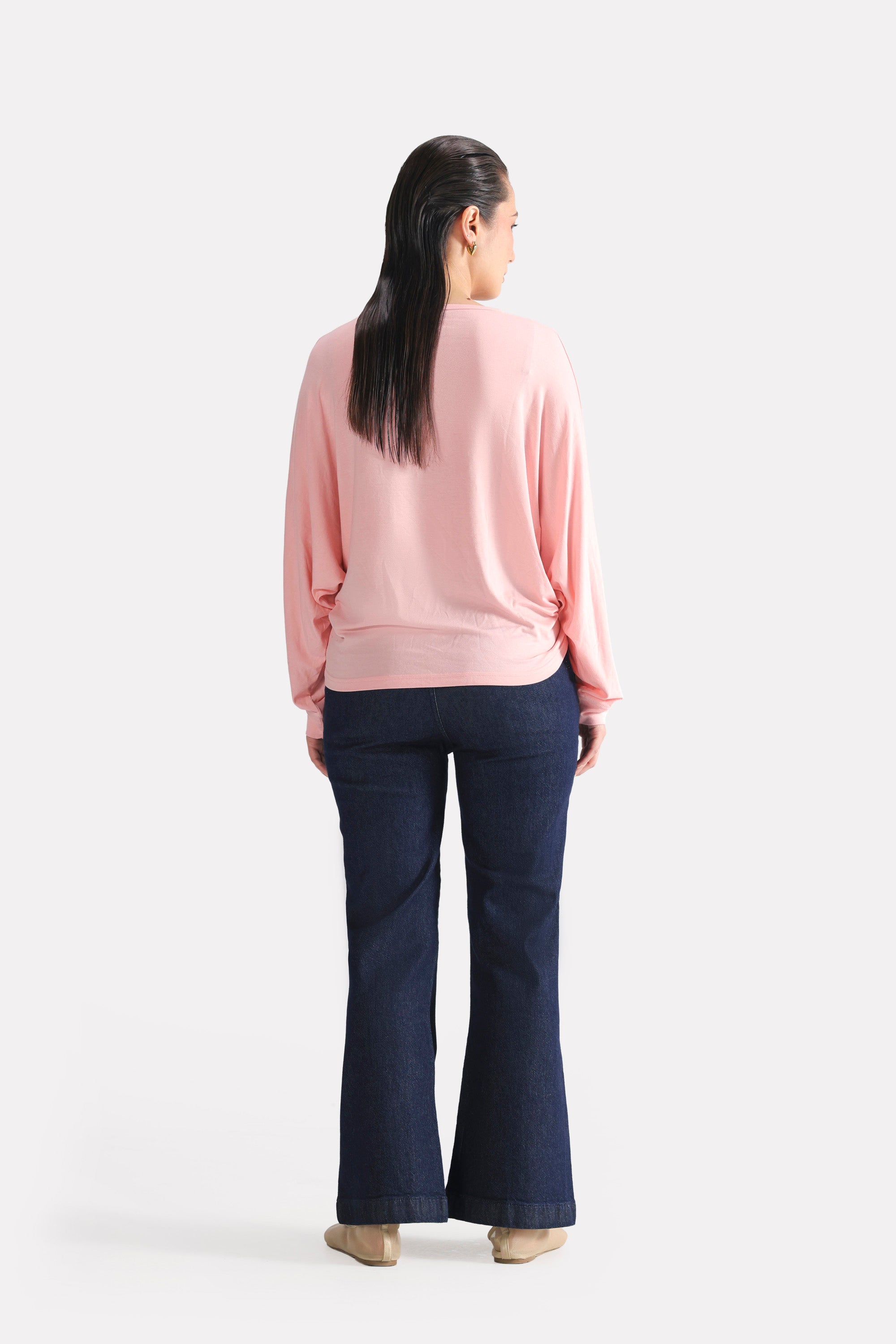 Light pink fluid sleeve t-shirt shown in a styled fit, by SOLA Pakistan.