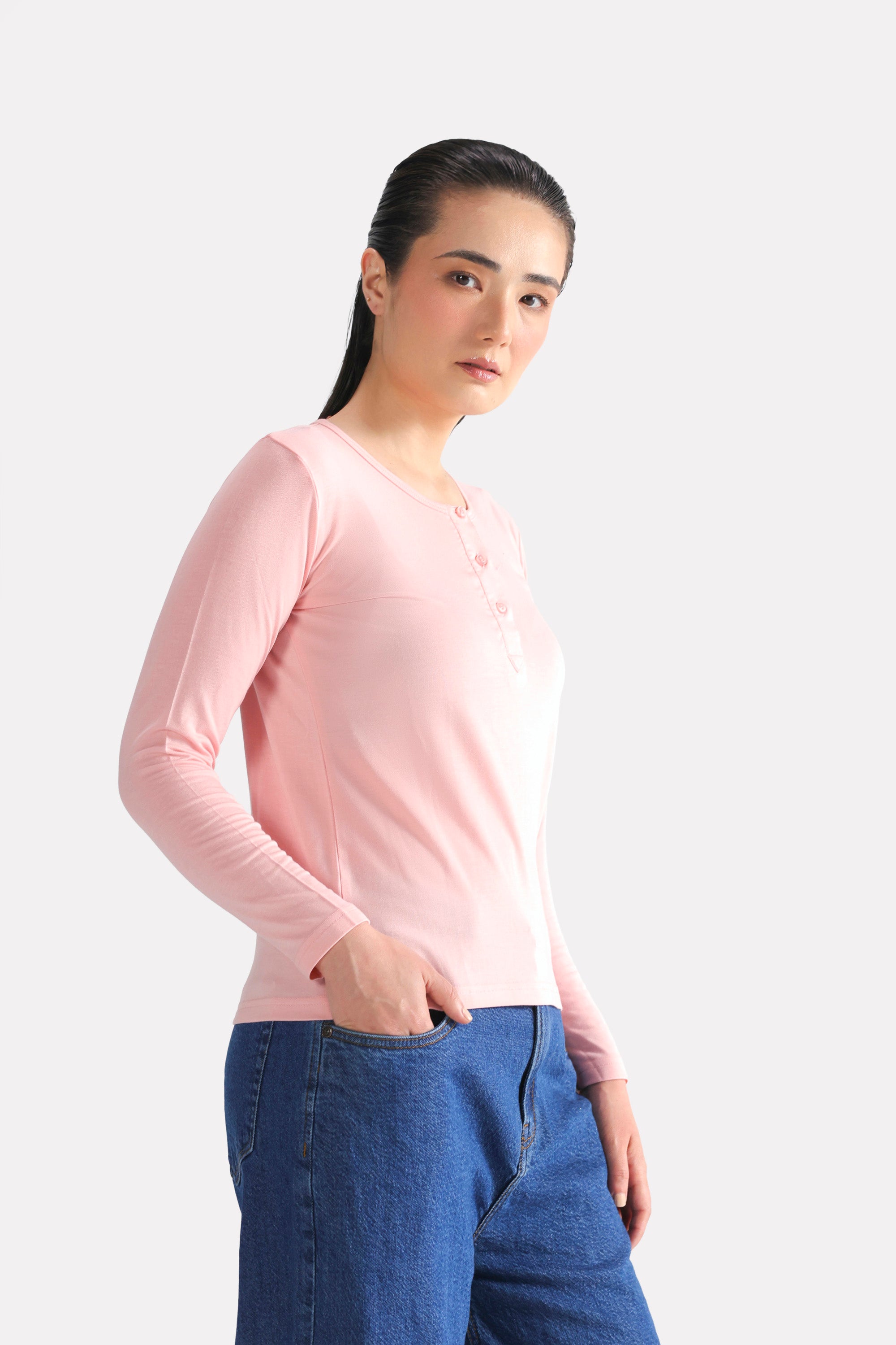 Close-up detail on the light pink henley t-shirt, by SOLA Pakistan.
