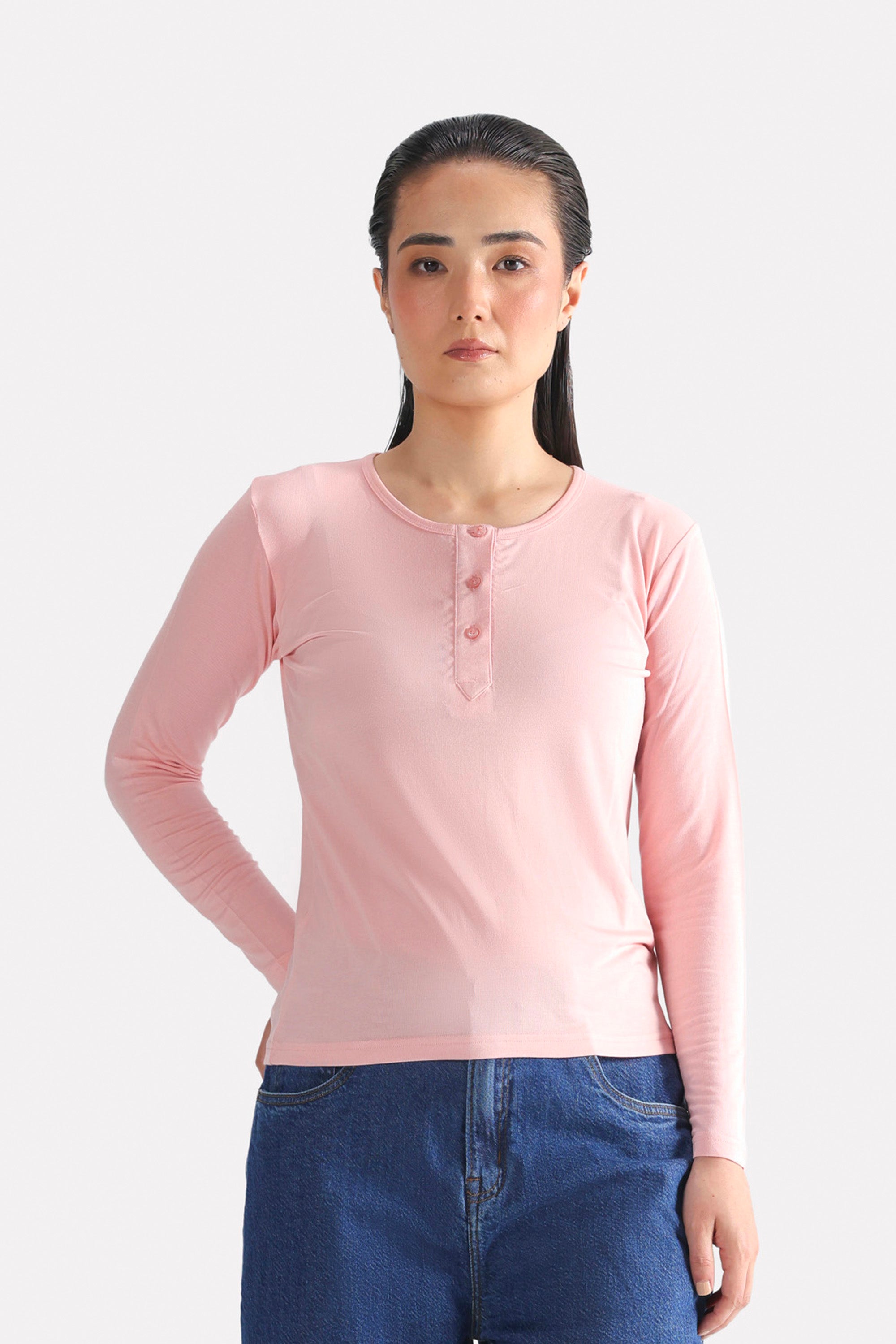 Light pink henley t-shirt in modal, worn by a model, by SOLA Pakistan.