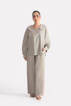 Mid grey structured ensemble bottom in cotton, worn by a model, by SOLA Pakistan.