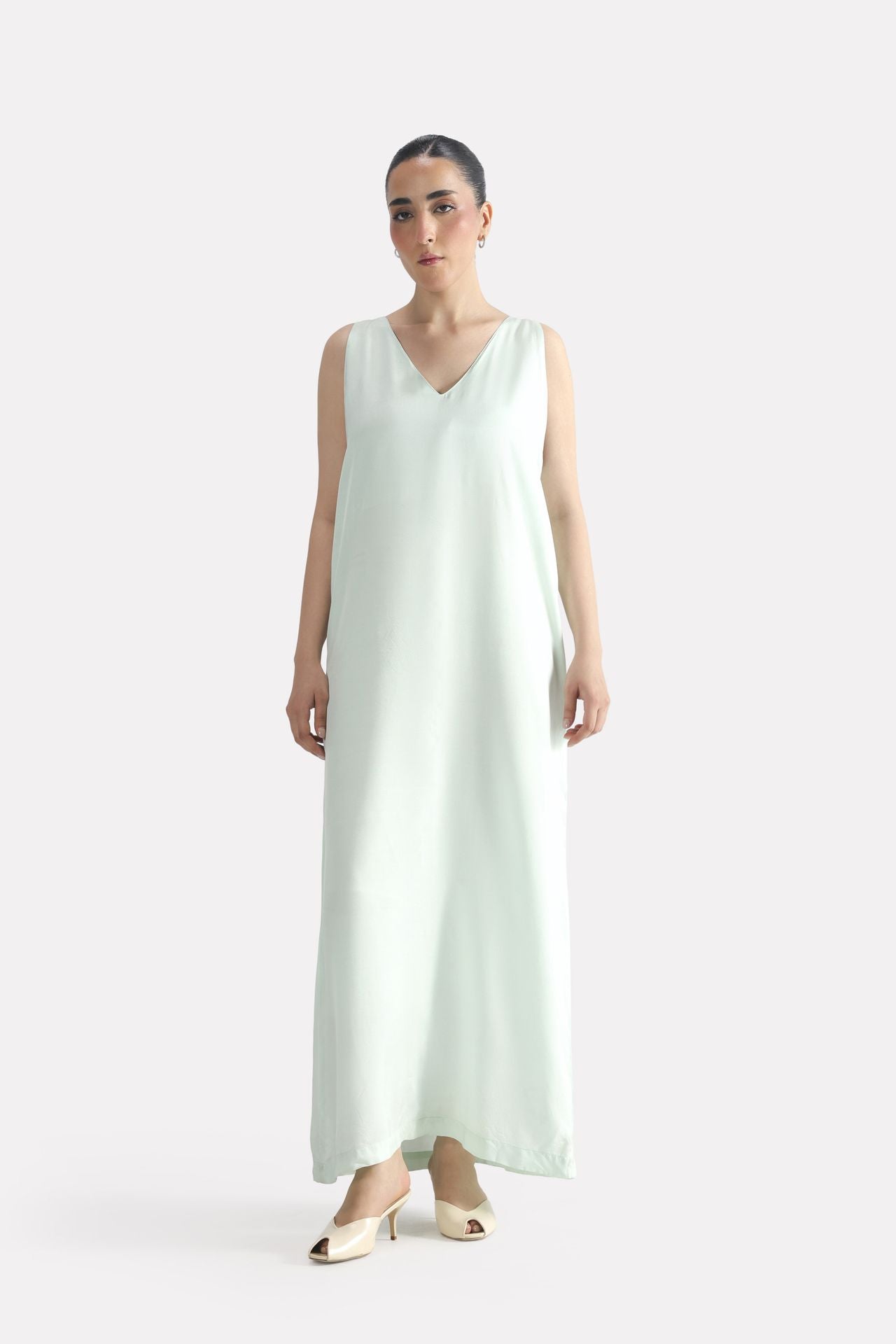 Mint green lyocell slip maxi dress, worn by a model, by SOLA Pakistan.