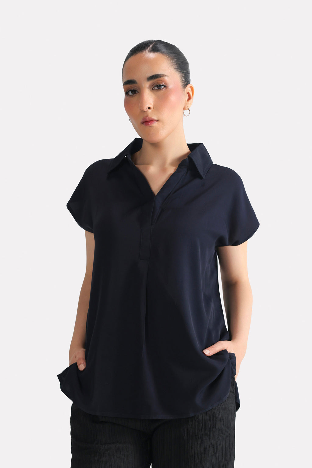 Navy blue minimal cap sleeve woven shirt in cotton, worn by a model, by SOLA Pakistan.