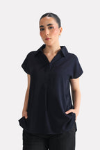 Navy blue minimal cap sleeve woven shirt in cotton, worn by a model, by SOLA Pakistan.