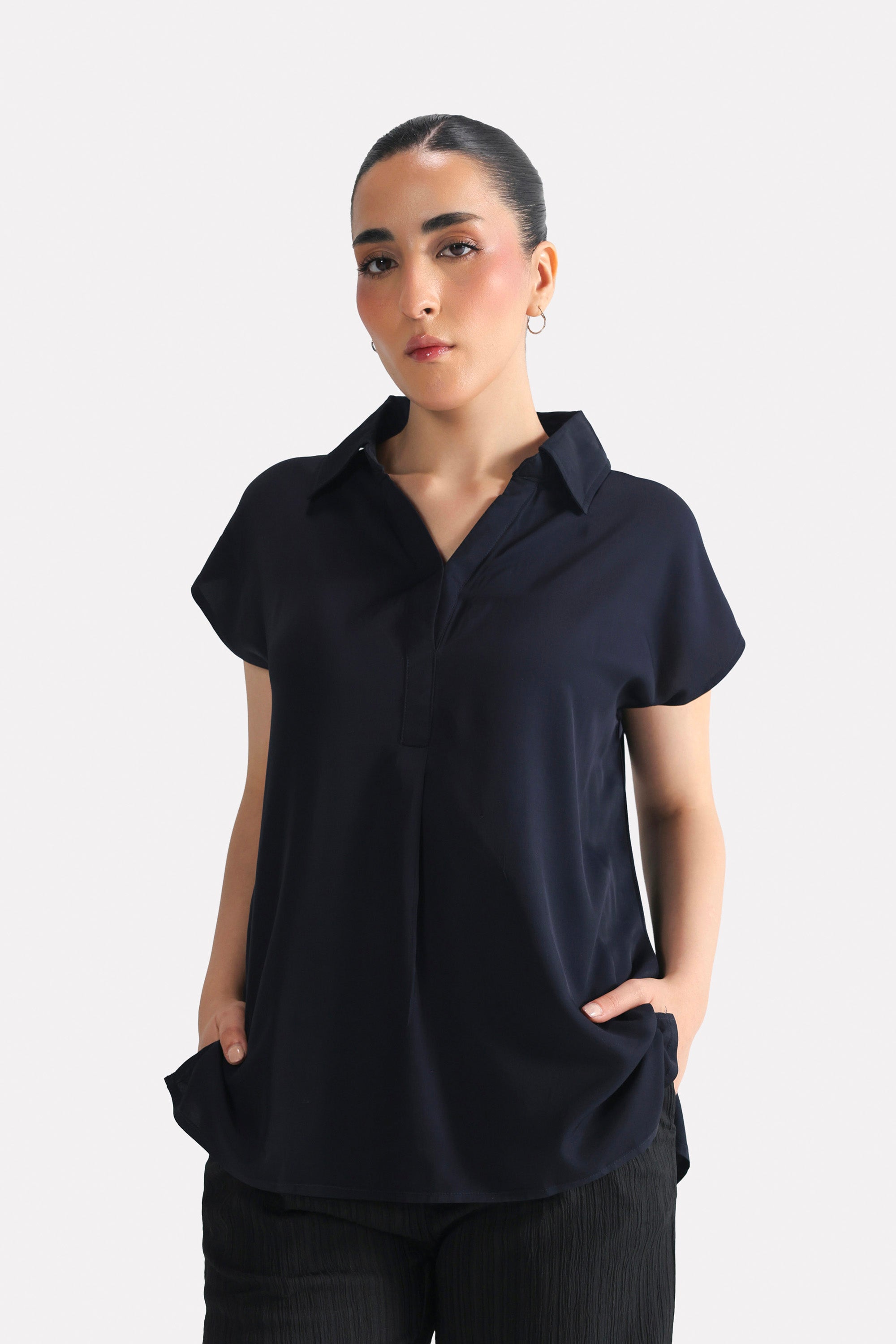 Navy blue minimal cap sleeve woven shirt in cotton, worn by a model, by SOLA Pakistan.