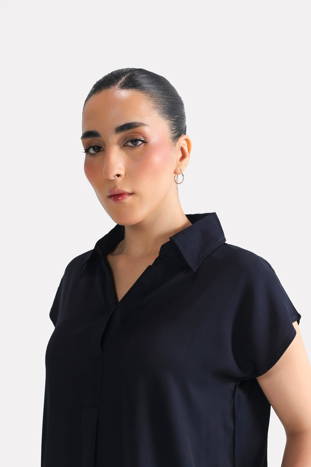 Texture and fabric detail, navy blue minimal cap sleeve woven shirt, by SOLA Pakistan.