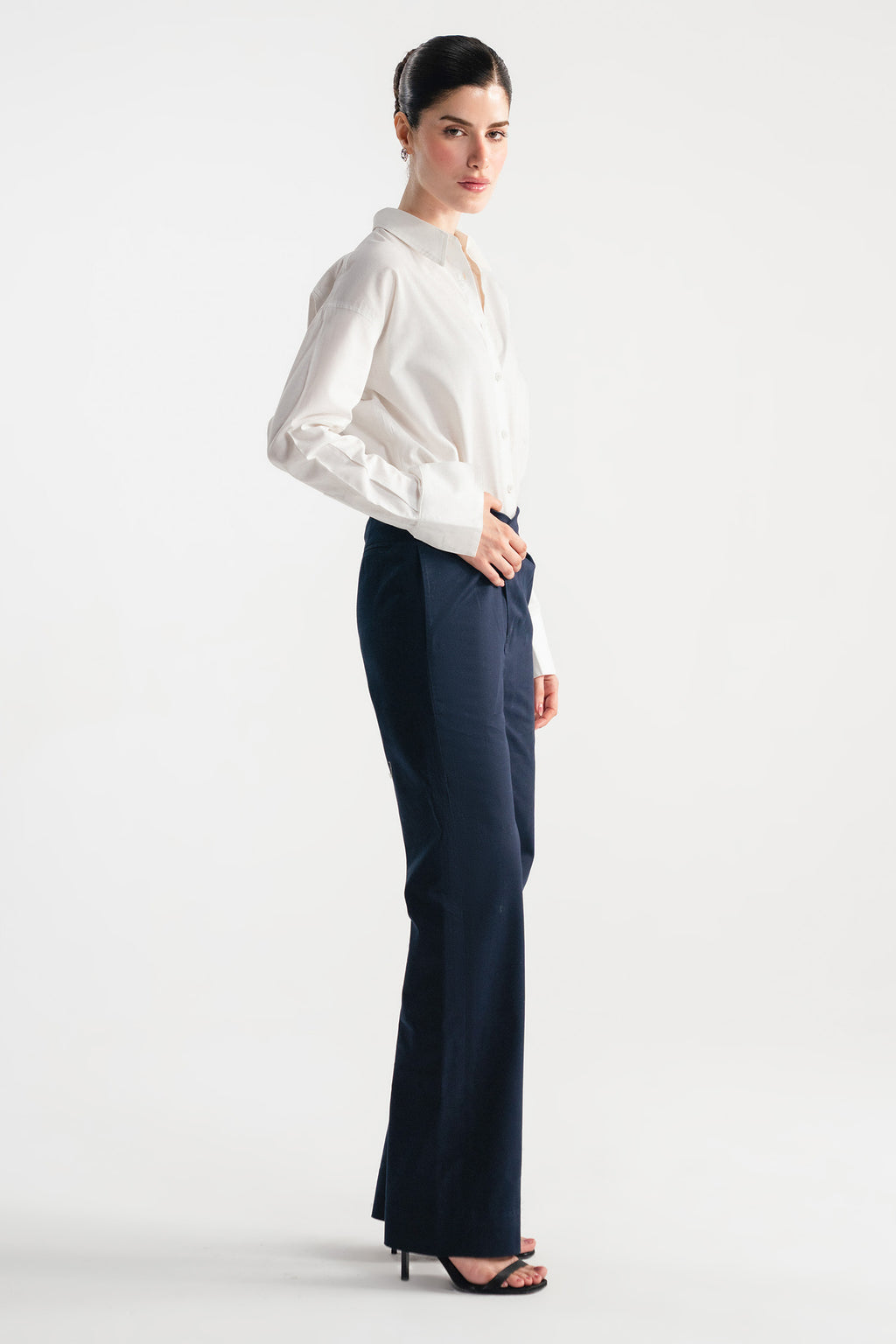 Close-up detail on the navy blue sculpted high waisted layered wide leg trouser, by SOLA Pakistan.