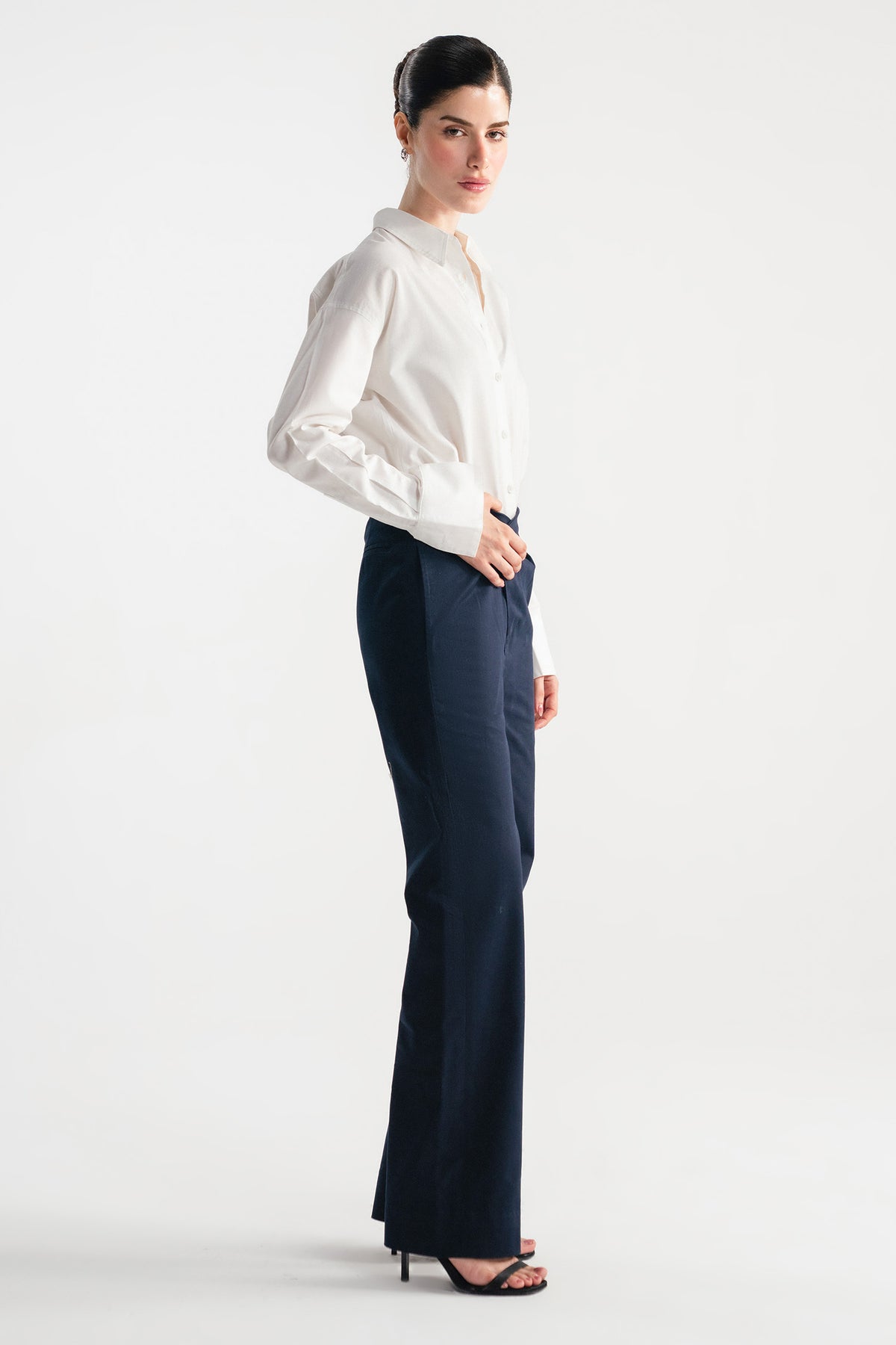 Close-up detail on the navy blue sculpted high waisted layered wide leg trouser, by SOLA Pakistan.