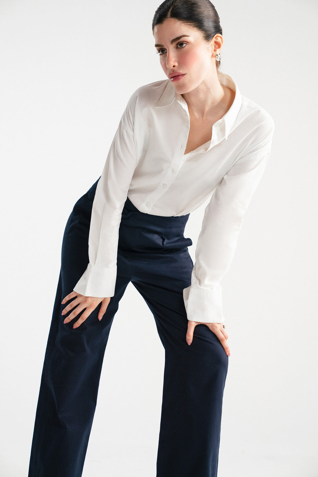 Navy blue sculpted high waisted layered wide leg trouser shown in a styled fit, by SOLA Pakistan.