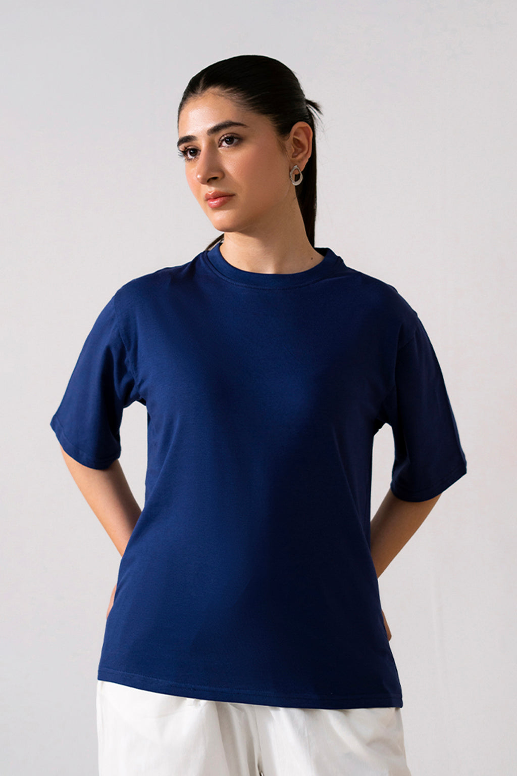 Navy round neck t-shirt in cotton, worn by a model, by SOLA Pakistan.