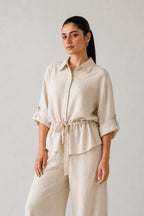 Off white cinched waist top in cotton-linen blend, worn by a model, by SOLA Pakistan.