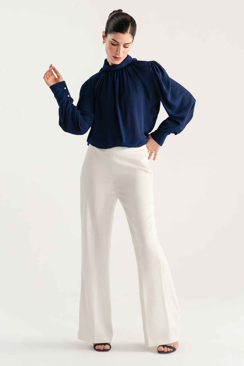 Close-up detail on the off white high waisted clean wide leg tailored, by SOLA Pakistan.