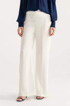 Off white high waisted clean wide leg tailored, worn by a model, by SOLA Pakistan.