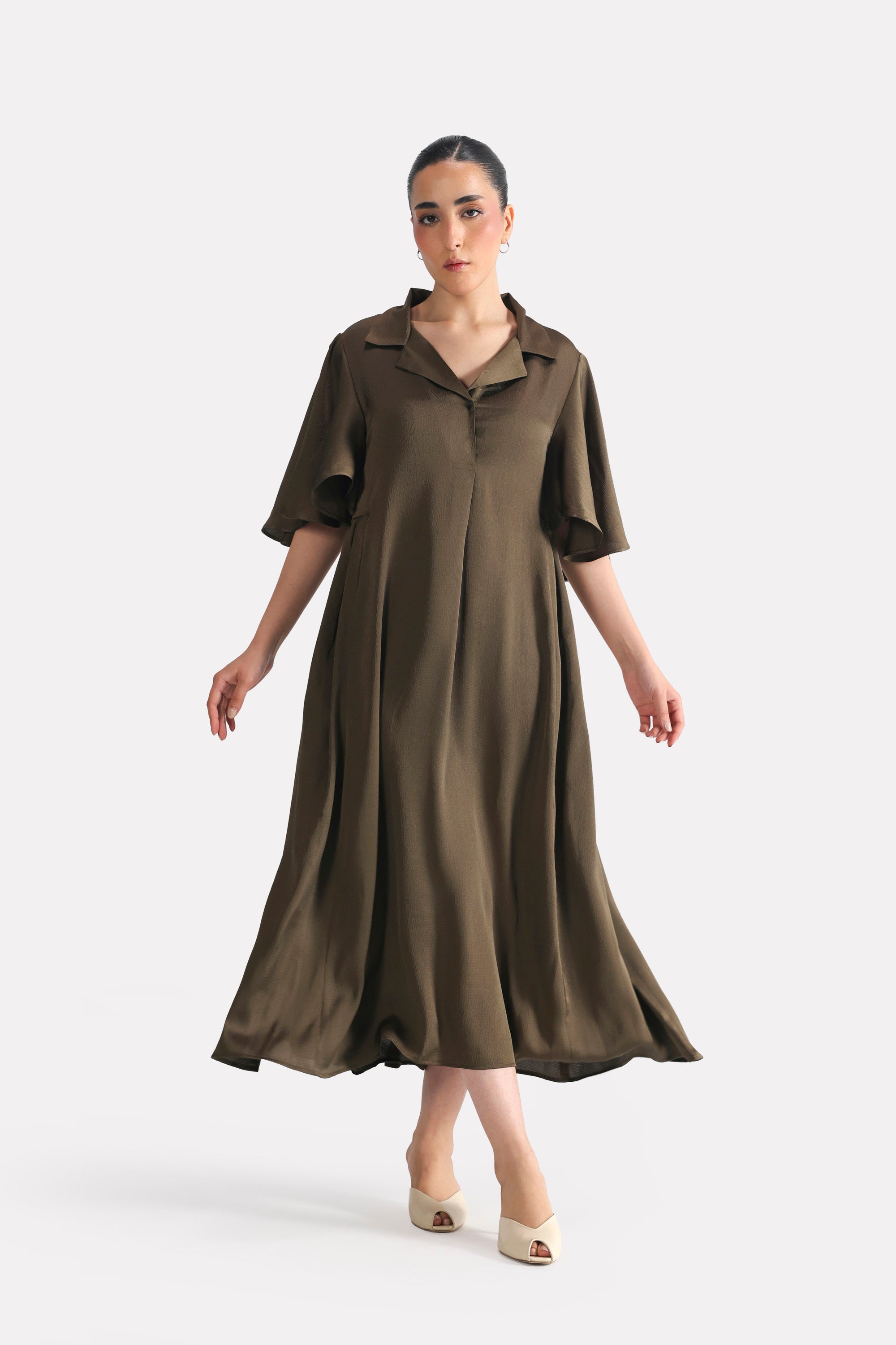 Olive green (deep olive) relaxed midi dress in silk, worn by a model, by SOLA Pakistan.
