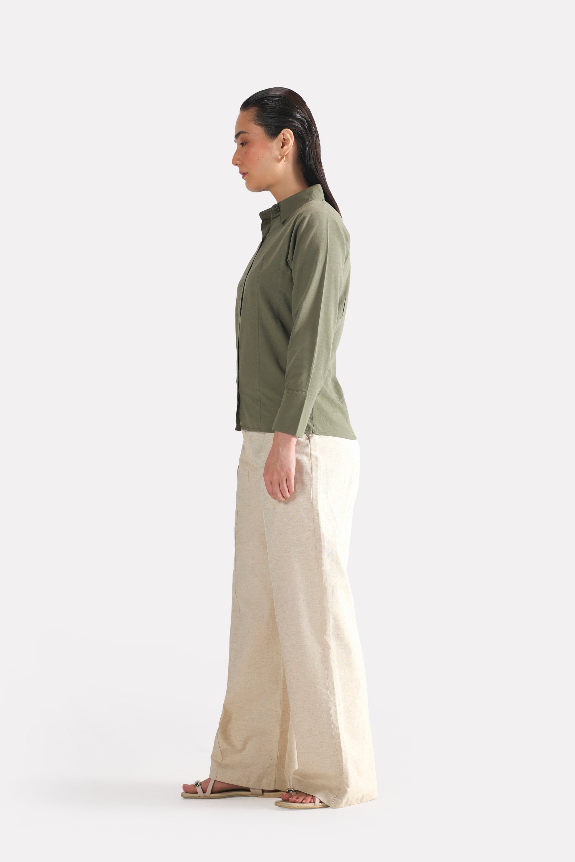 Flat lay of the olive refined pleated woven shirt, by SOLA Pakistan.