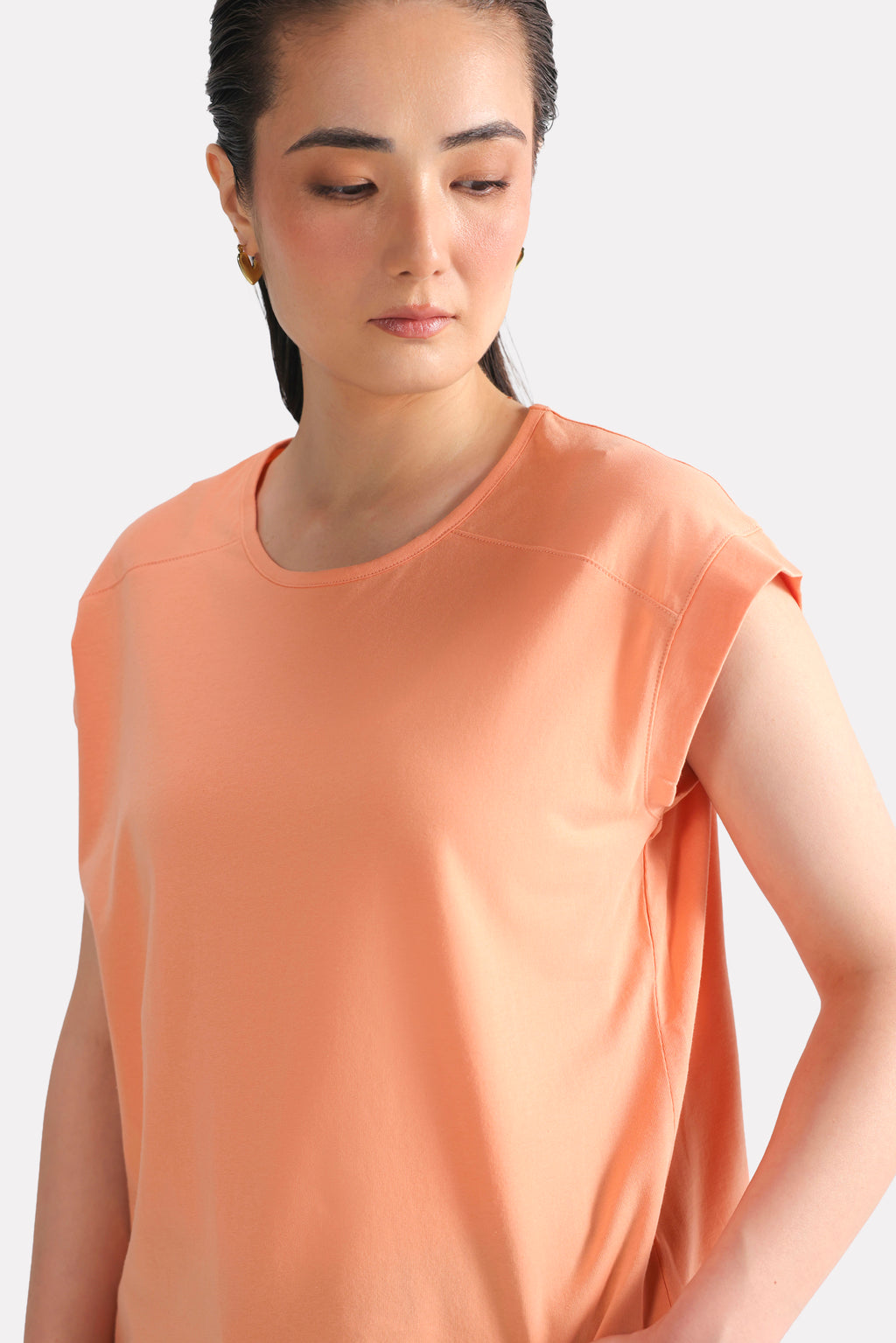 Peach (apricot) relaxed shoulder-tab t-shirt, full styled look, by SOLA Pakistan.