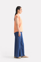 Peach (apricot) relaxed shoulder-tab t-shirt shown in a styled fit, by SOLA Pakistan.