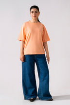 Peach (apricot) round neck t-shirt shown in a styled fit, by SOLA Pakistan.