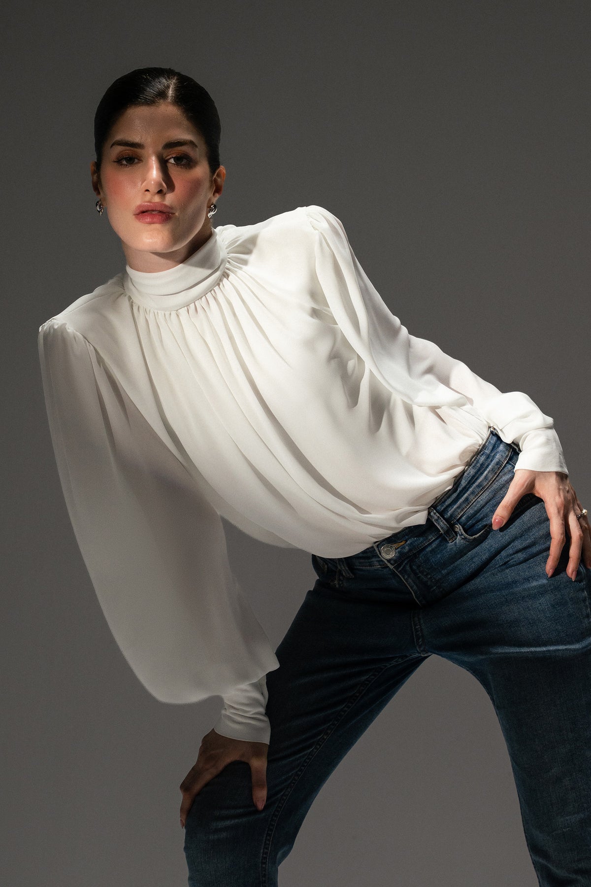 Flat lay of the pearl white gathered highneck blouse, by SOLA Pakistan.