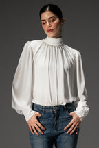 Pearl white gathered highneck blouse, worn by a model, by SOLA Pakistan.
