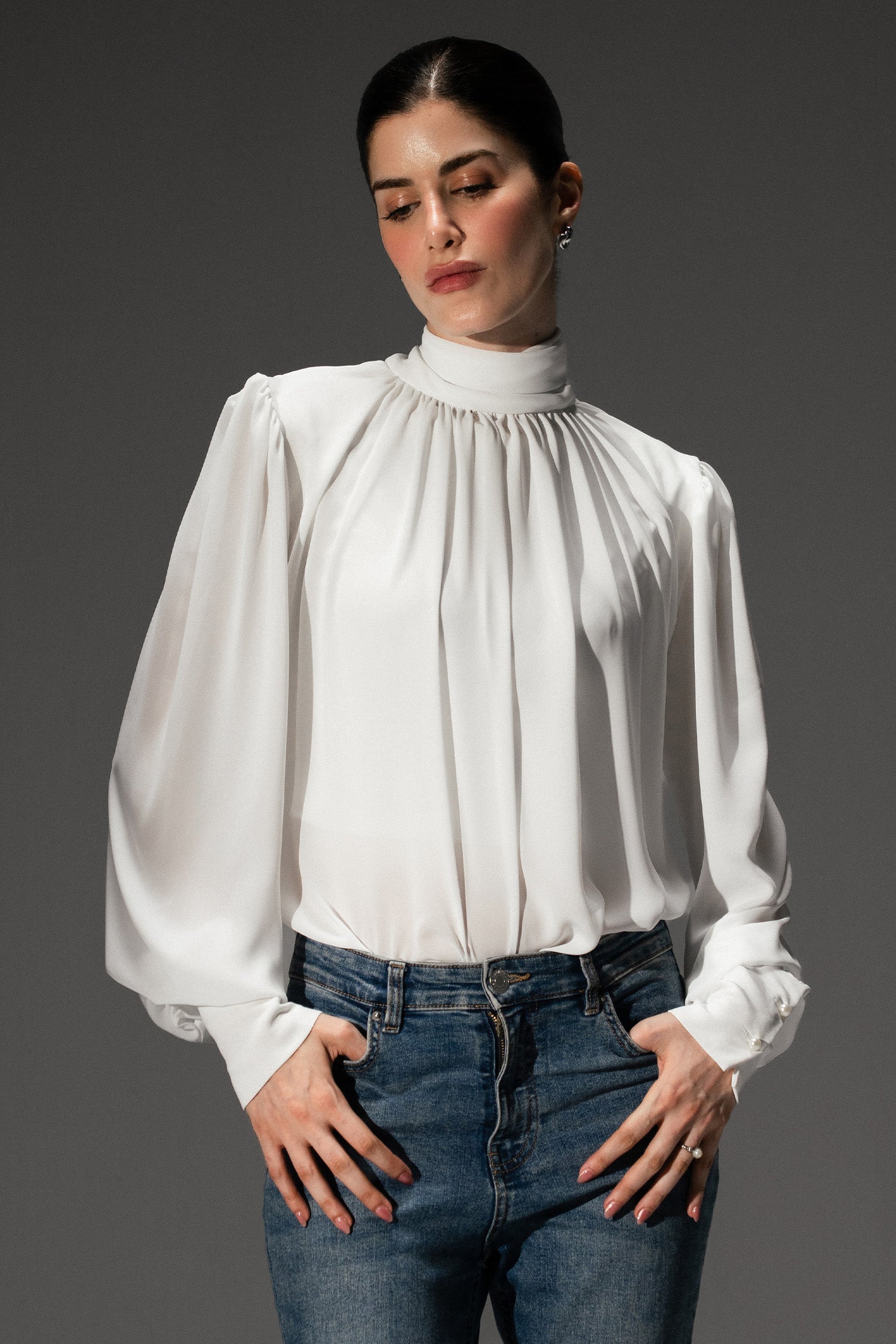 Pearl white gathered highneck blouse, worn by a model, by SOLA Pakistan.