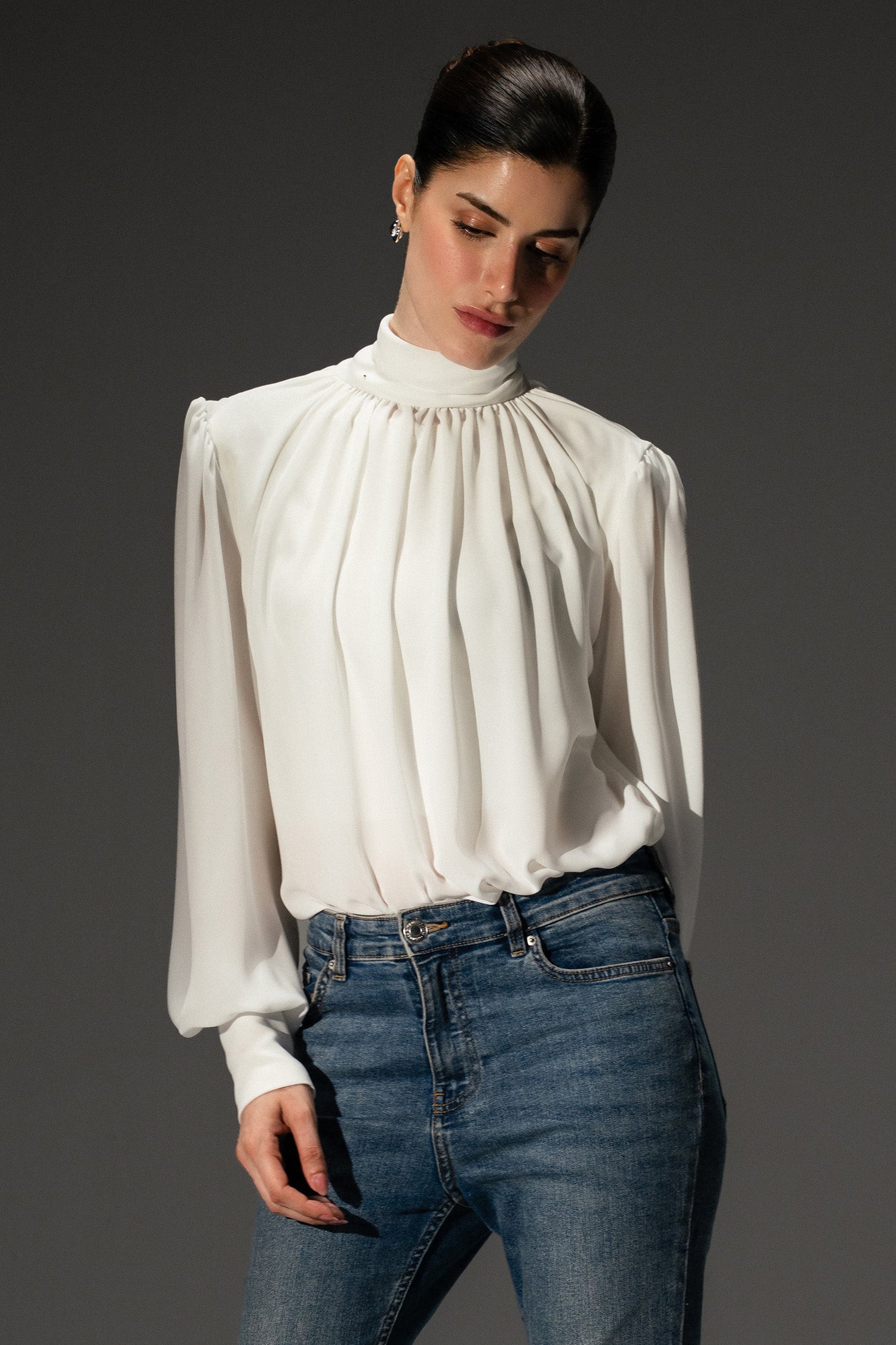 Pearl white gathered highneck blouse shown in a styled fit, by SOLA Pakistan.