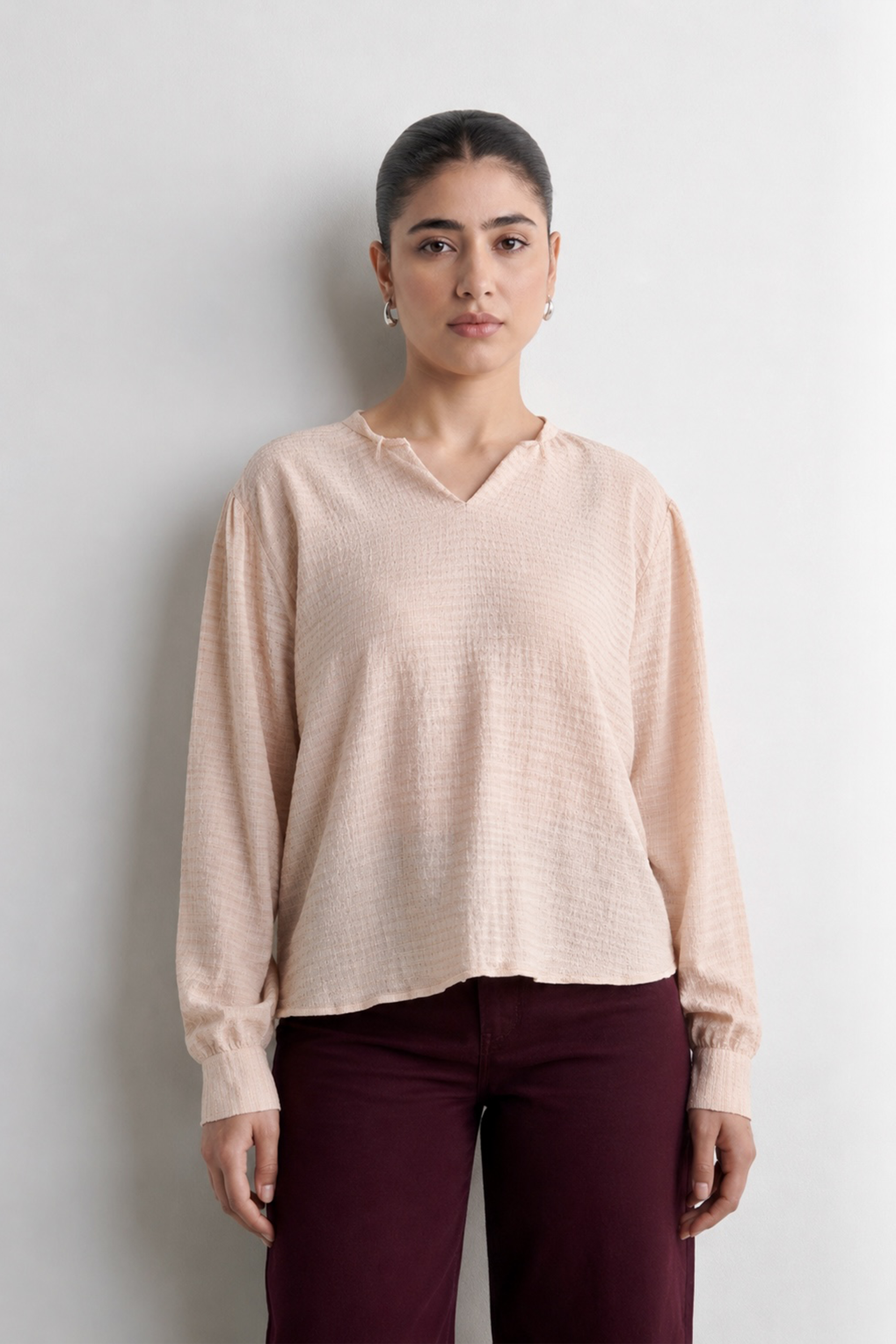 Pink powder pink top in polyester crepe, worn by a model, by SOLA Pakistan.