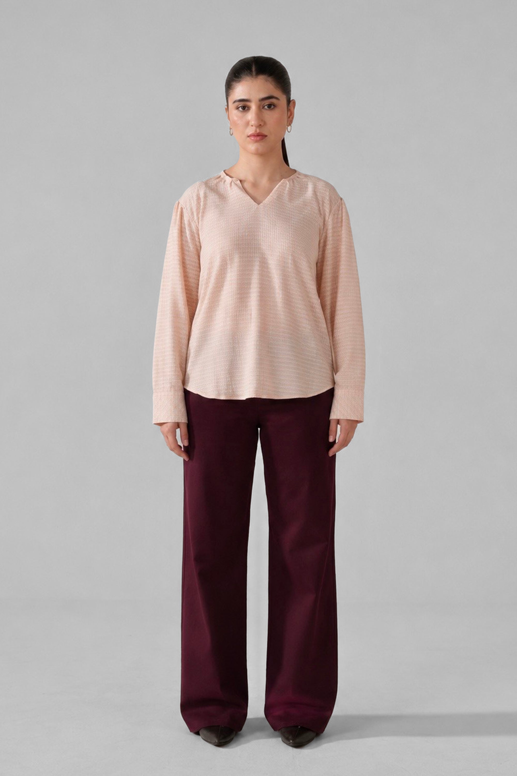 Pink powder pink top shown in a styled fit, by SOLA Pakistan.